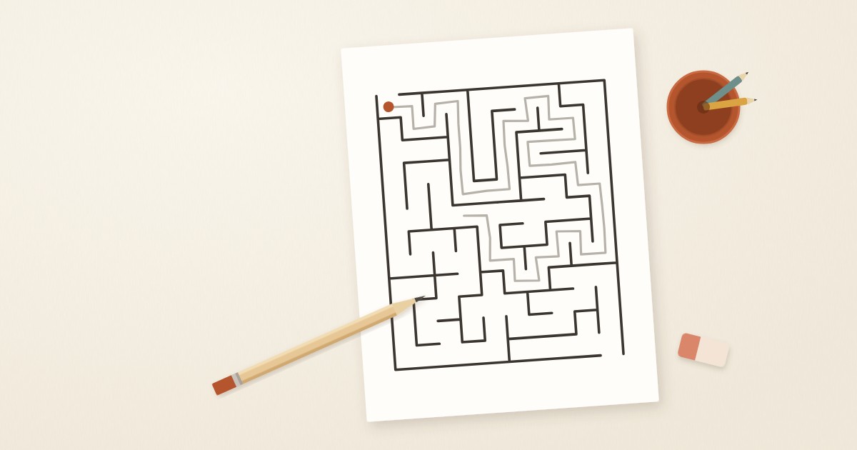 A printable maze on white paper with a pencil beside it, on a warm cream desk.